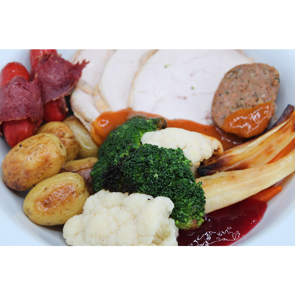 Roast Turkey With Stuffing And Cranberry Sauce Served With Chipolatas